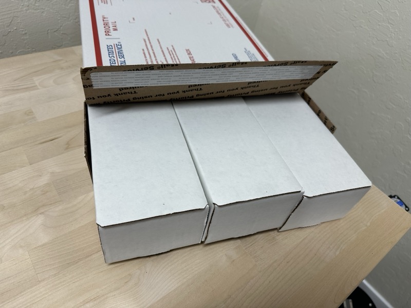 Three BCW boxes fitting snugly inside a USPS Medium Flat Rate box