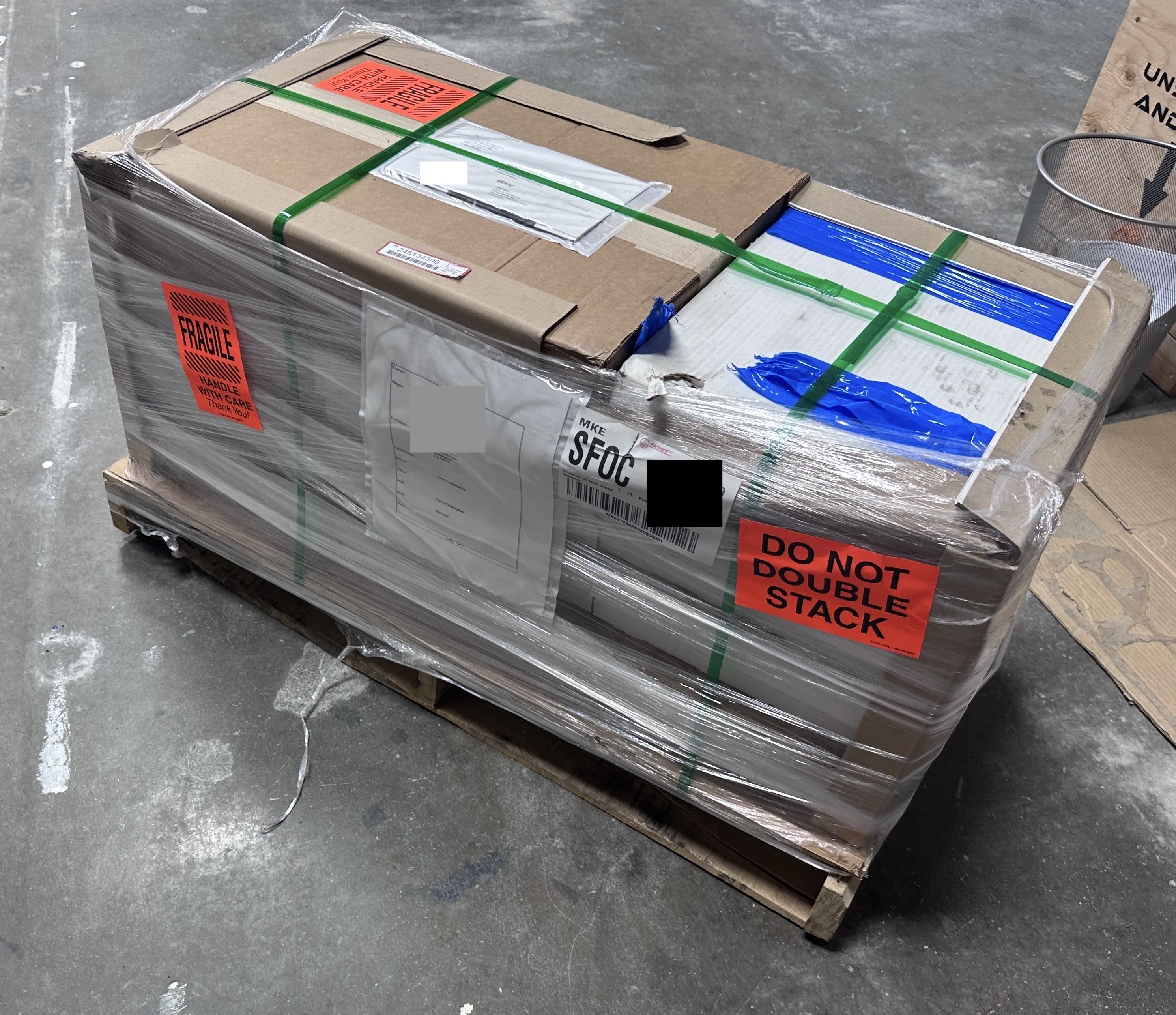 A shrink-wrapped pallet stacked with boxes of cards, ready for freight shipping